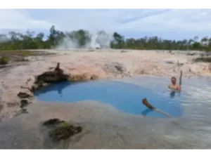 A tourist bathing in a geothermal hot spring at Deidei on Fergusson Island, Milne Bay Province, PNG