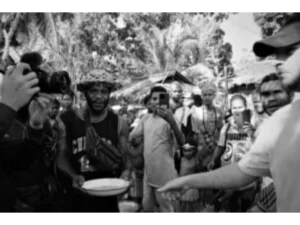 A man giving tourists a taste of the sago mona made at Bwabwasai village on Sanaroa Island