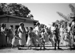 Village women dancing while the men strum guitars in a welcome song for the first tourists to Sanaroa Island at Bwabwasai village