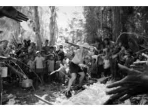 One of the first tourists to visit Sanaroa Island taking part in a sago making activity at Bwabwasai village